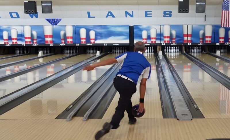 A focused bowler prepares to release the ball